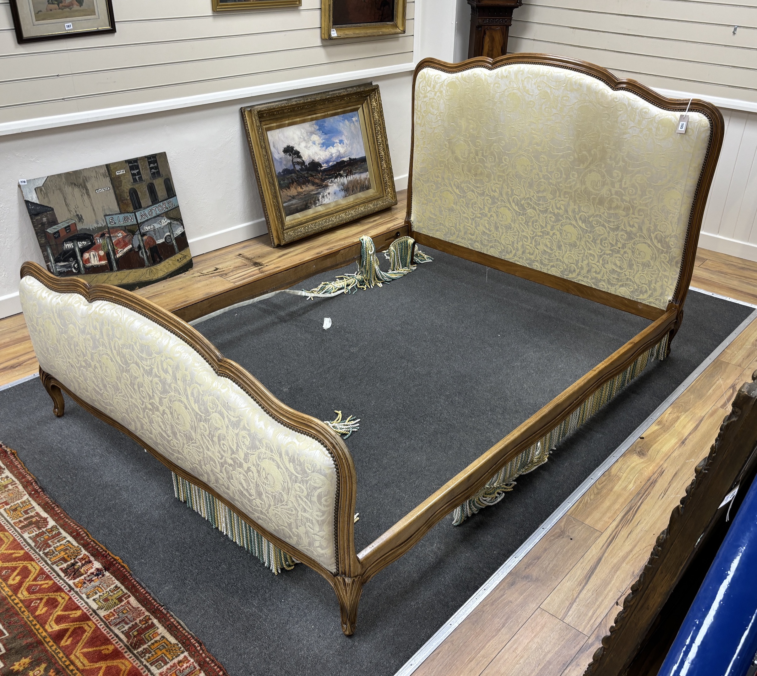 A Louis XVI style upholstered walnut double bedframe, width 156cm, length 220cm, height 123cm.